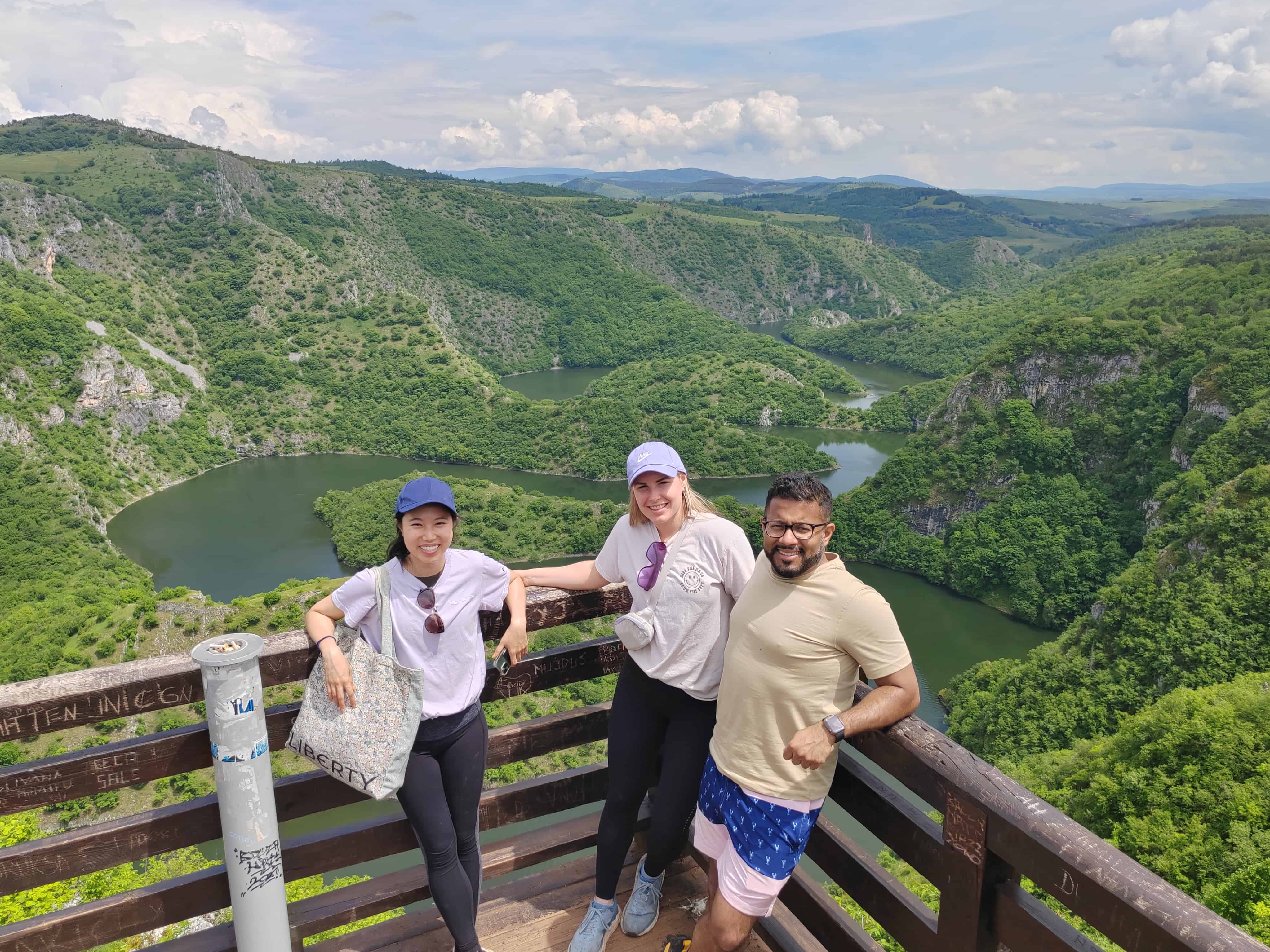 Panoramic view of Uvac canyon and river wth three people posing on a picture