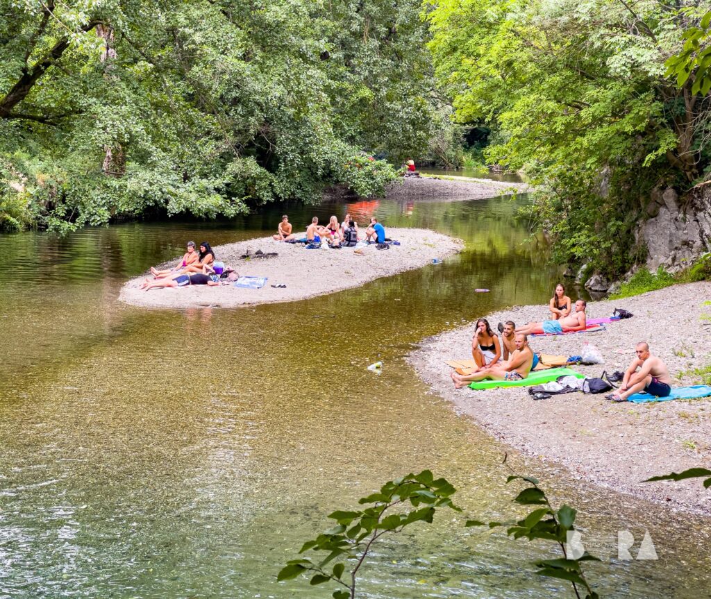 Campers relaxing on riverbanks at Gradac River – fantastic camping spot for summer adventure and nature escape