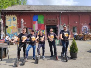 Group of tourists on e-scooter craft beer tour in front of Dogma Brewery, Belgrade
