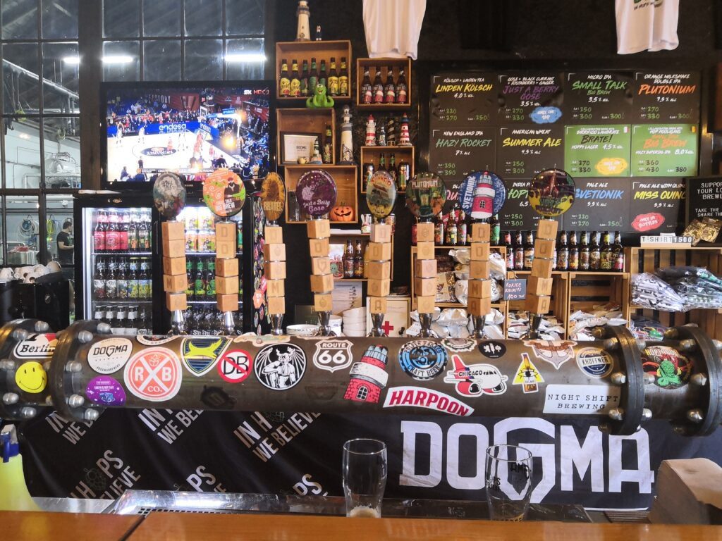 Craft beer taps at Dogma Brewery in Belgrade showcasing their exclusive house-made beers.