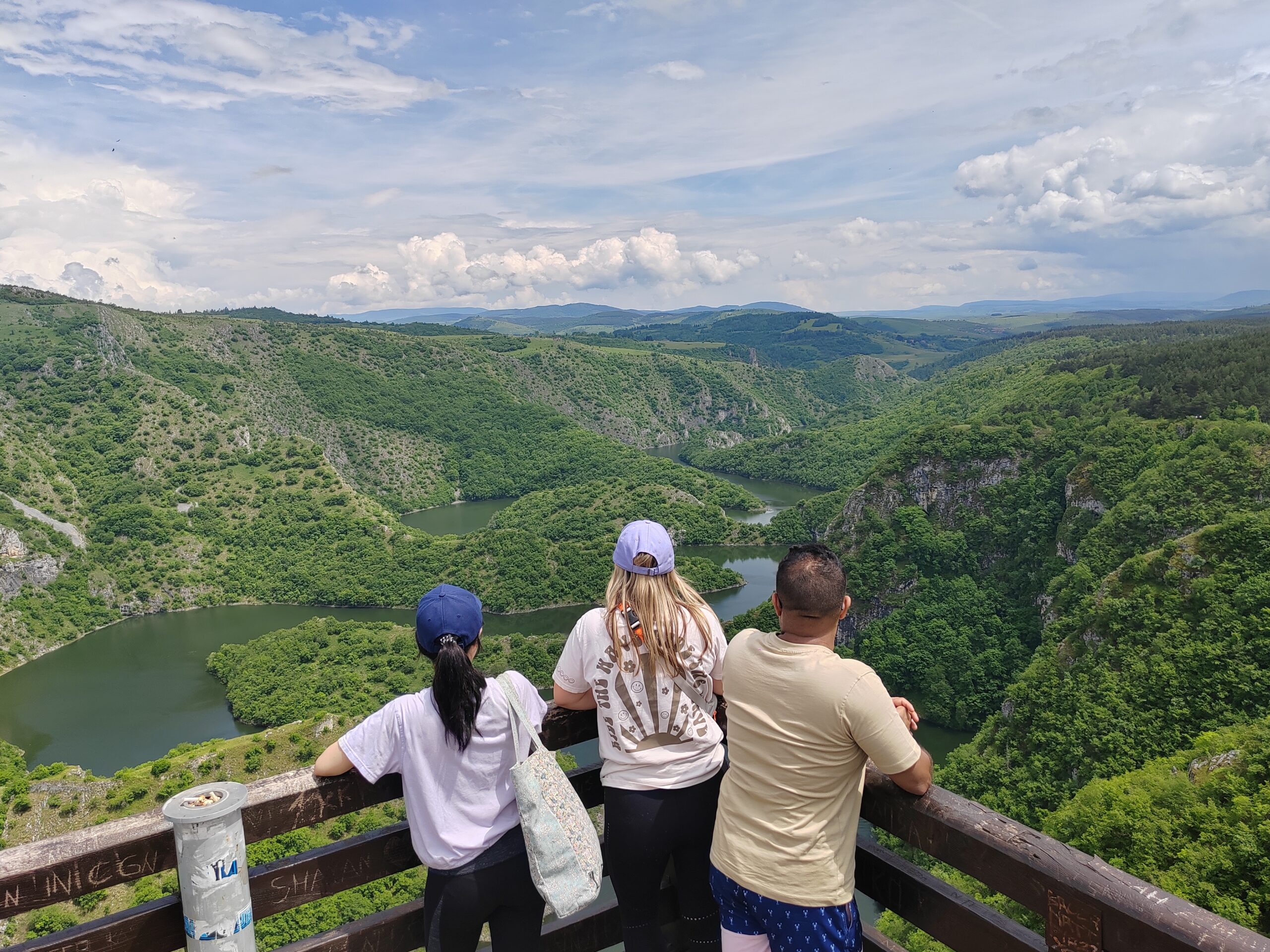 View of the Uvac Canyon with three people admiring the landscape from a scenic viewpoint