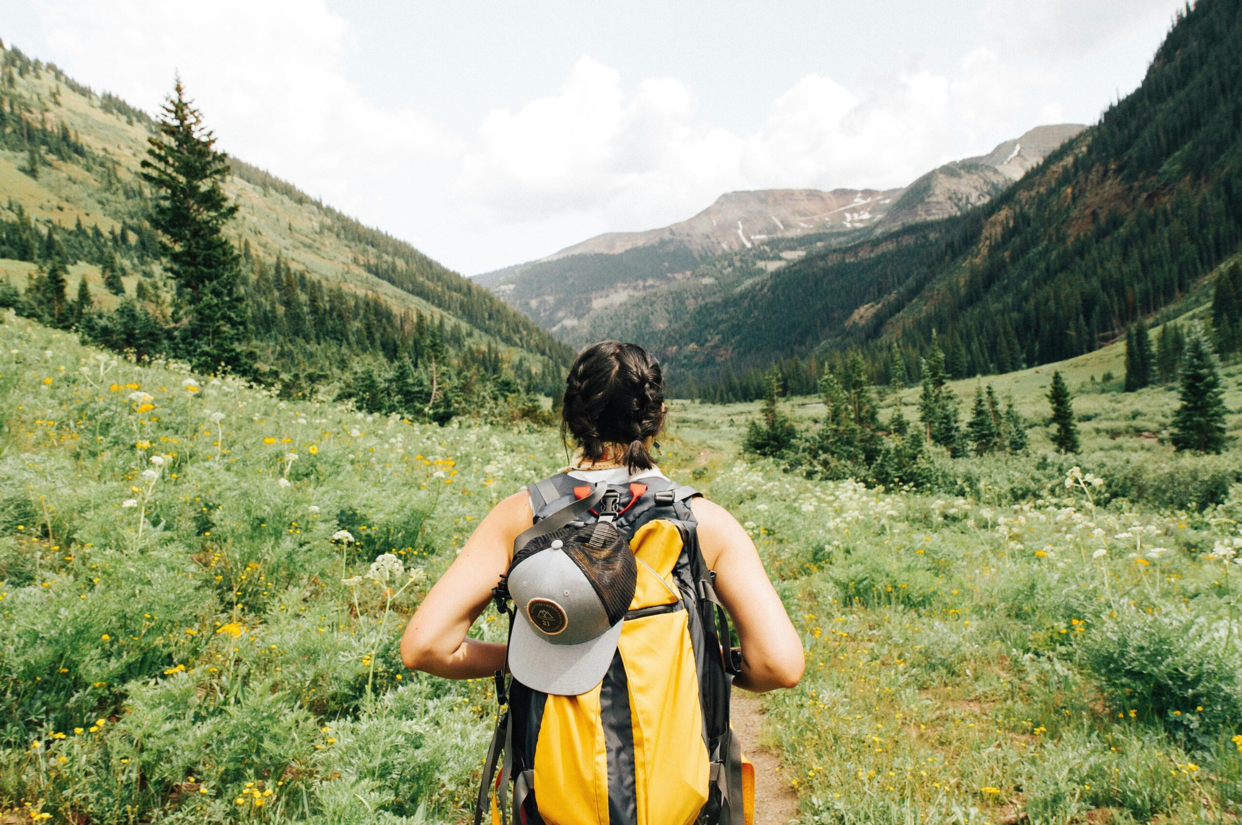Solo female traveler with backpack exploring European nature trail – perfect for solo travel Europe adventures