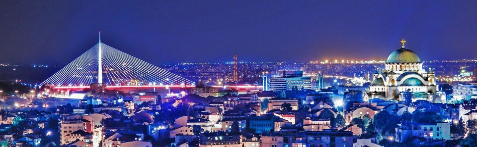 Night view of Belgrade skyline with illuminated bridges and city lights