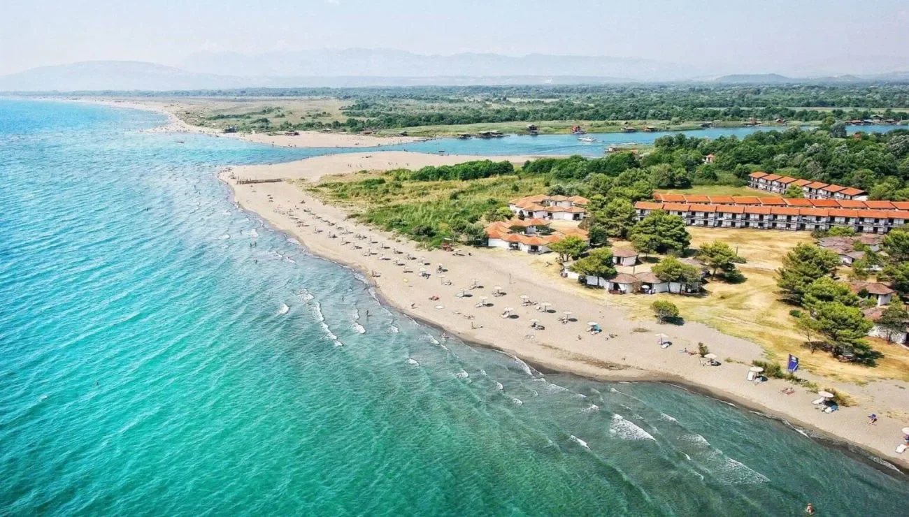 Camping tents on Ada Bojana beach, Montenegro, with sunset over the Adriatic Sea