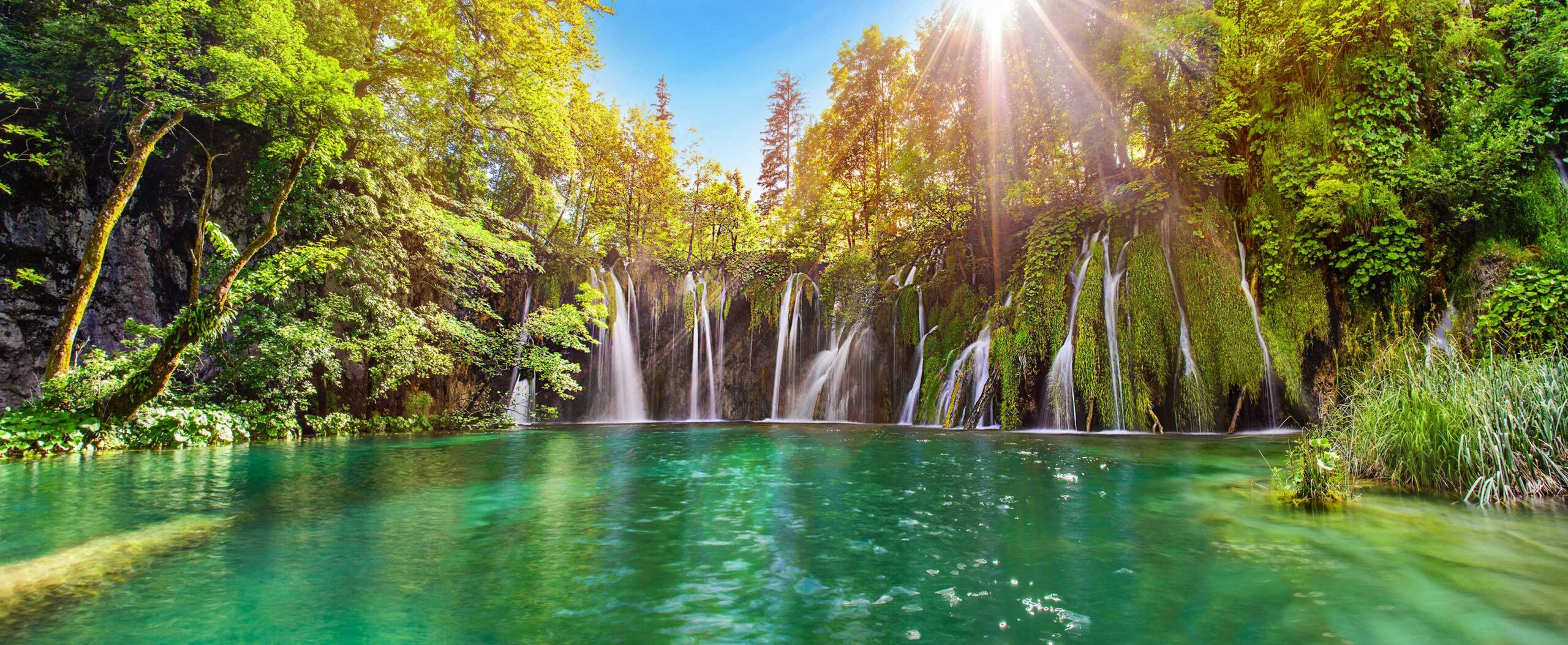 Wonderful waterfall in Croatia sorounded by greenery and blue sky