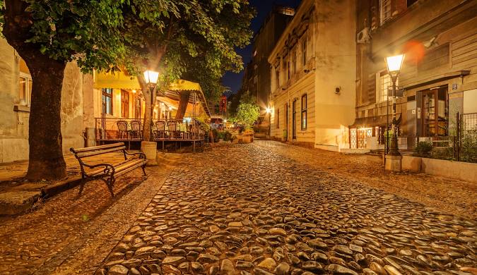 Skadarlija street at night with cobblestones and vintage lanterns — one of the best Belgrade attractions